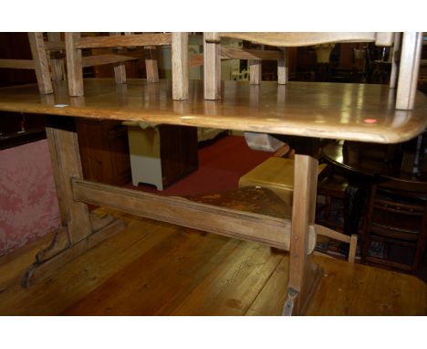 An Ercol mid-elm dining suite comprising; dining table and four ladderback dining chairs (2+2) (5)