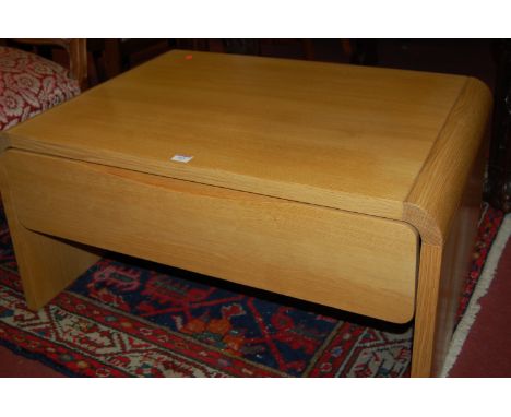 A contemporary light oak two drawer coffee table 