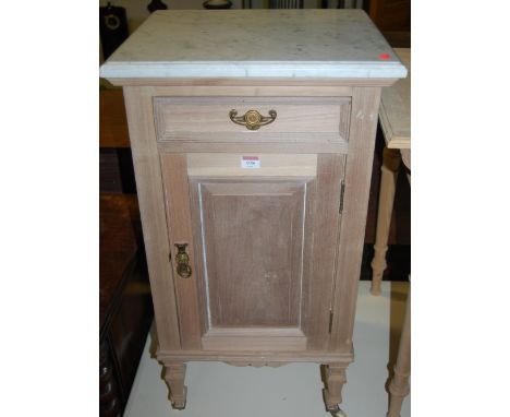 An Edwardian stripped walnut and white marble topped single door bedside cupboard; together with an Edwardian single drawer s