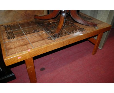 A 1970s teak and tile top coffee table 