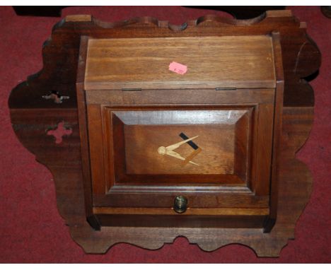 A pair of walnut single door hanging corner cupboards, each panel door inlaid with masonic emblems 