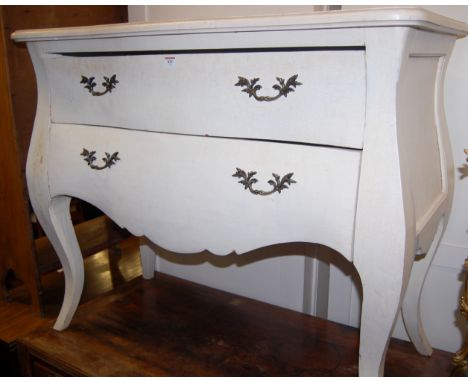 A French style white painted two drawer serpentine front commode