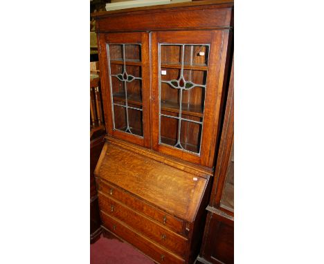 An early 20th century oak lead glazed bureau bookcase Condition Report / Extra Information Top right hand panel on right hand