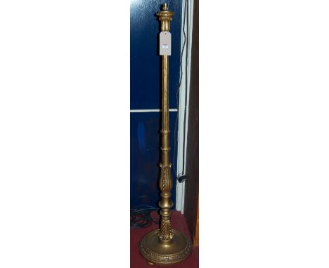 An early 20th century carved giltwood standard lamp of floral and reeded form