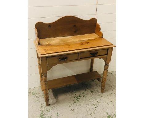 A double pine wash stand with two drawers on turned legs and lower shelf 