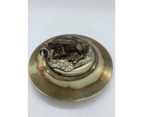 A silver cow finial on a silver plated base lid 