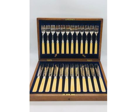 A 24 piece boxed set of silver plated fish knives and forks with keys 