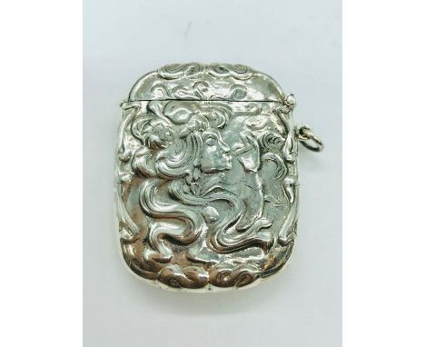 A silver vesta case with embossed decoration in an art nouveau style 