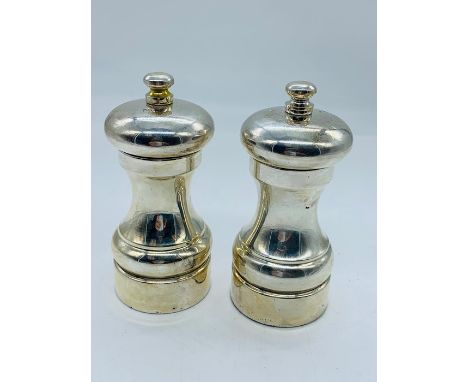 A silver salt and pepper set hallmarked for the year 2000 by maker MCH