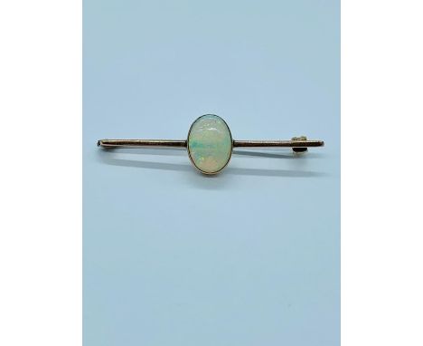 Fire opal brooch in a yellow metal setting 