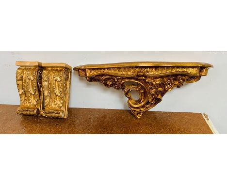 A Pair of shelf bracket sconces in gold gilt and a gold gilt wall shelf