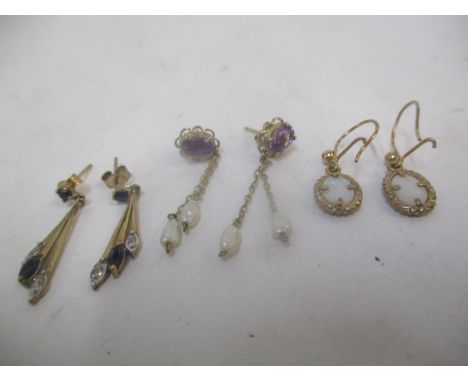 Three pairs of gold coloured earrings, one set with diamonds and sapphires, another with amethyst and pearls and others with 