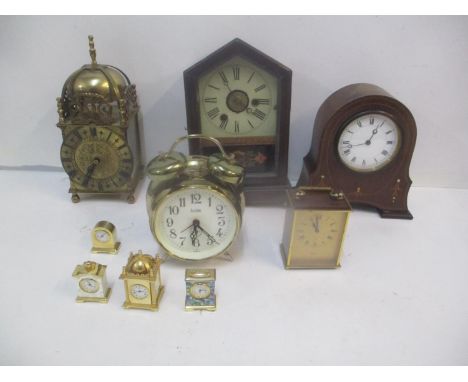 Clocks to include a brass quartz lantern clock, a German clock, an Edwardian mantle clock, four miniature examples and others