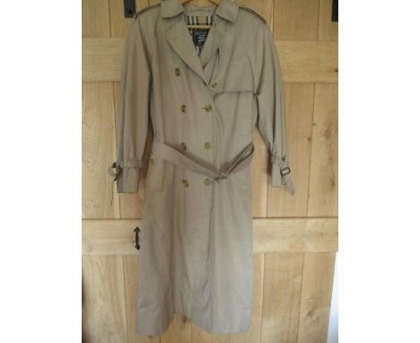 A Burberry's ladies light beige trench coat with iconic lining, UK size 12 Long, approx measurements 36" chest x48" Long.Cond