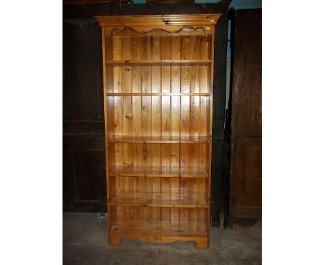A TALL SOLID PINE BOOK SHELF/CASE,&nbsp;H 184 cm, D 260 - 300 cm, W 84.5 - 93 cm