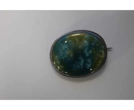 A CHARLES HORNER AND RUSKIN SILVER BROOCH