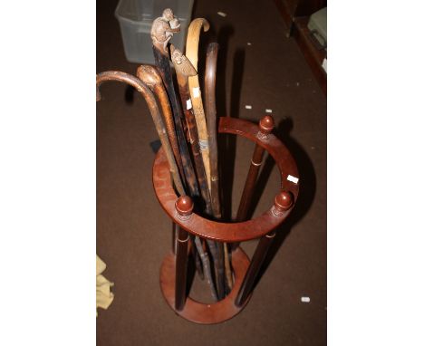 A STICK STAND AND A COLLECTION OF WALKING STICKS