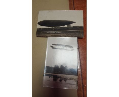 A GLASS PAPERWEIGHT OR PICTURE FRAME INCLUDING A POSTCARD OF THE FIRST WORLD WAR AIRSHIP "THE PARSEVAL" AND ANOTHER OF A VERY