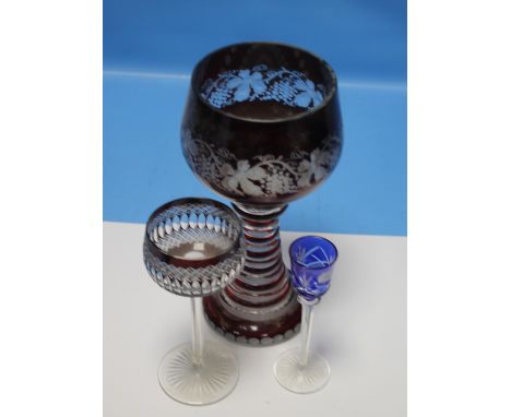 A LARGE BOHEMIAN RUBY OVERLAY GLASS GOBLET WITH GRAPE AND VINE DECORATION TOGETHER WITH TWO OTHER GLASSES  (3)