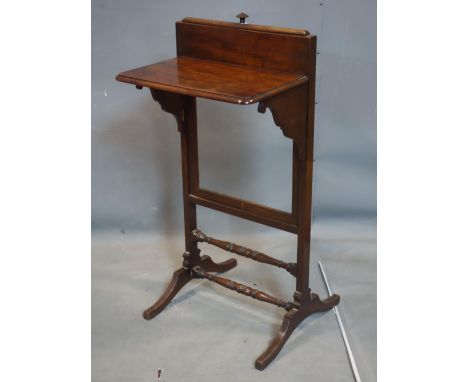 An Edwardian mahogany adjustable fire screen, lacking panel 