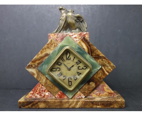A French Art Deco marble on onyx mantle alarm clock by DEP, c.1930s, with diamond shaped dial with Roman numerals, H.18.5 W.1