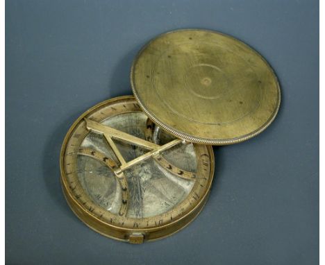 A George III brass pocket compass, the circular lidded body with interior glass, silvered dial and folding gnomon, 8cm (3ins)