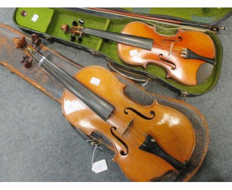 An early 20th century violin with a one piece back and scroll head, together with bow and case, and another cased violin, wit