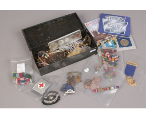 A tin of collectables to include enamel badges, coins, medal bars etc. 
