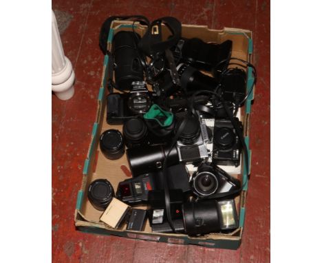 A box of cameras and lenses to include Olympus OM10, Canon, Minolta, Praktica etc. 