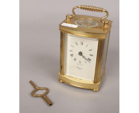 A Rapport carriage clock with open top escapement and Roman numeral markers. 