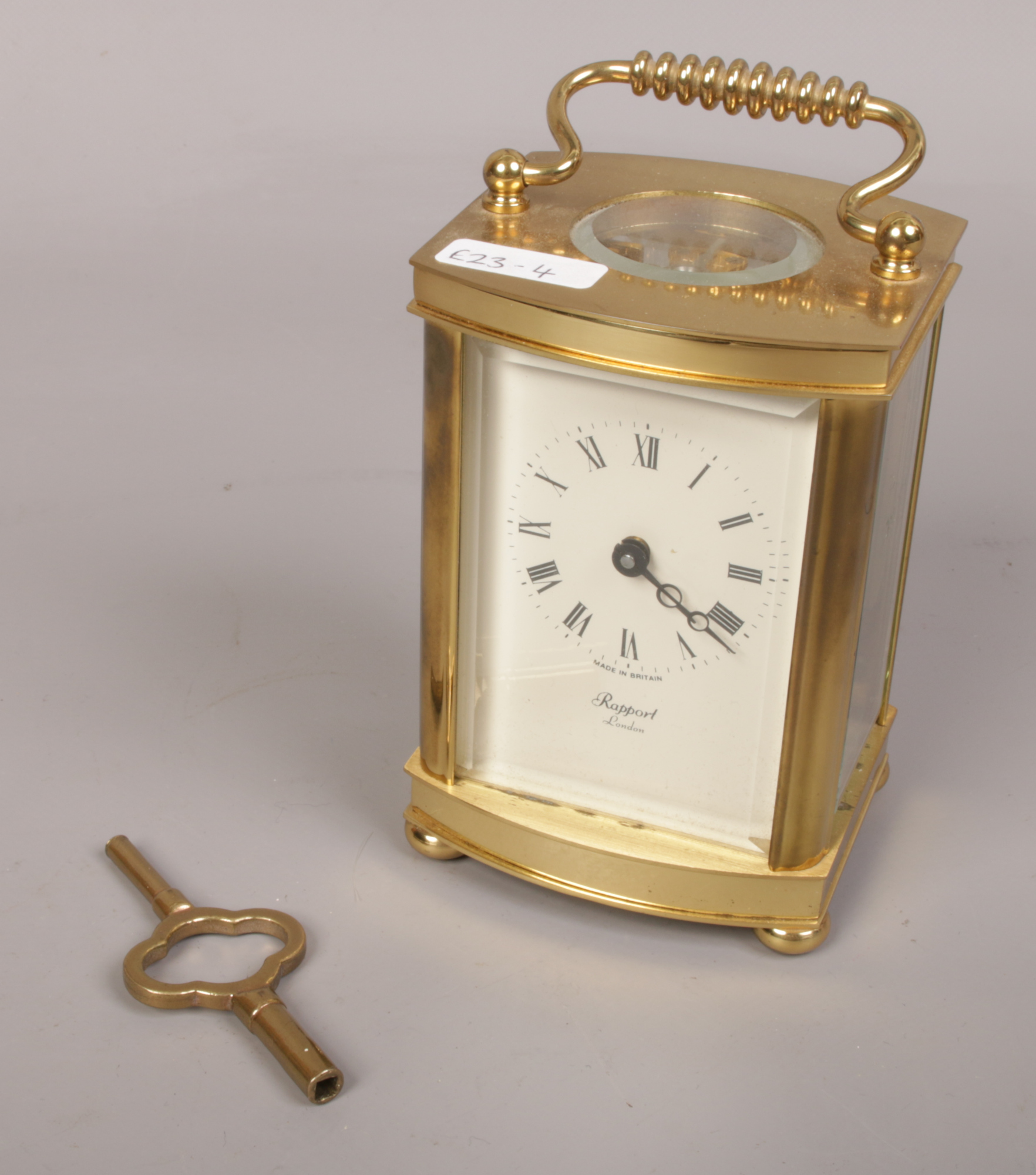 A Rapport carriage clock with open top escapement and Roman numeral