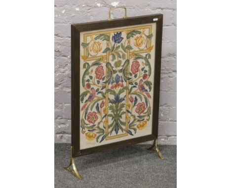 A wooden framed embroidered firescreen. 