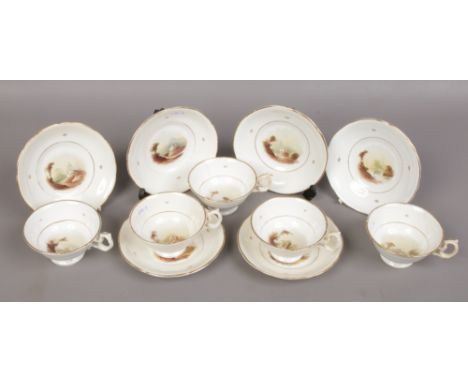 Five 19th century porcelain cups and saucers, hand painted with landscape scenes, circa 1830. 