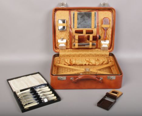 A boxed Voisin &amp; Co. French vinyl covered vanity case, along with a Colibri lighter and cased chrome plated cutlery. 