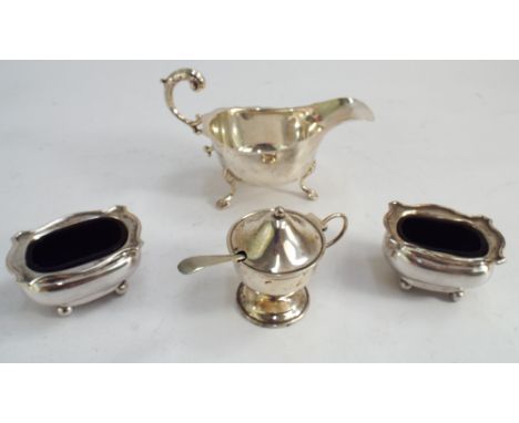 Silver sauce boat and a three piece silver cruet set, salts with blue glass liners. Weight excluding liners 5.25 troy ounces