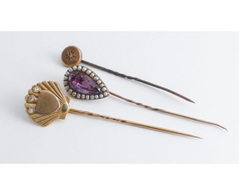 A group of three Victorian stick pins, one a tear drop shaped amethyst and pearl example, diamond set shell shaped pin  and a