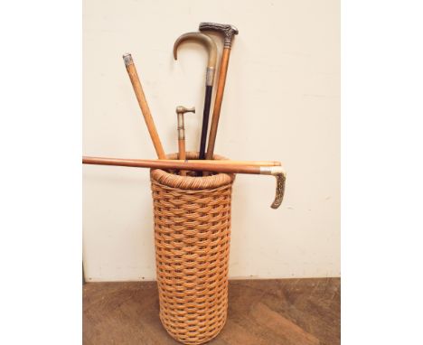 Wicker stick stand and 5 various silver mounted stick and riding crop