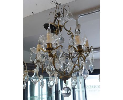 Gilt brass chandelier with glass lustre droplets and glass candle dishes.