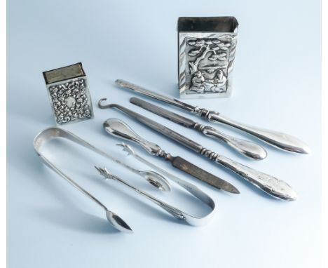 A collection of small silverware to include 2 matchbox covers, 2 pairs of sugar nips, dressing table accessories to include a