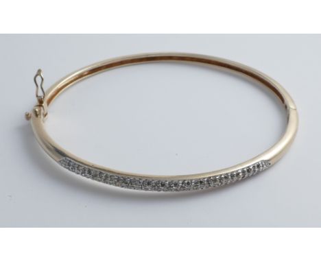 9ct yellow gold diamond set hinged bangle, one side pave set with brilliant cut diamonds, gross weight 11.1 grams