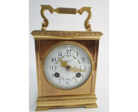 Gilt brass mantel clock with white enamel dial, signed L R Crouch, Cardiff - measures 21cm tall with handle up