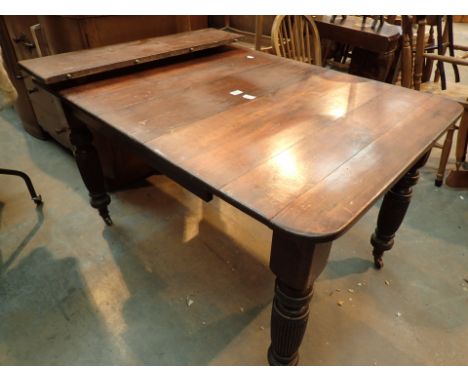 Sectional pine dining table with carved legs on castors 128 x 92 cm 