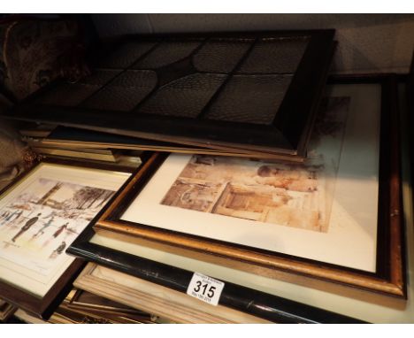 Shelf of mixed pictures including watercolours and a framed stained glass window