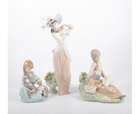 Lladro figure of a young lady with a broad rimmed bonnet, number 6280, 31cm; two other Lladro figures of girls with hats; a L