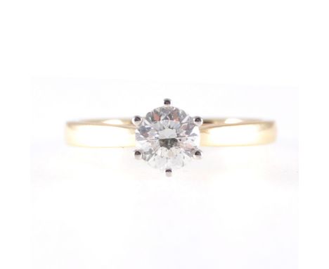 A diamond solitaire ring, the brilliant cut stone six claw set in an 18 carat yellow and white gold single stone mount, 2mm w