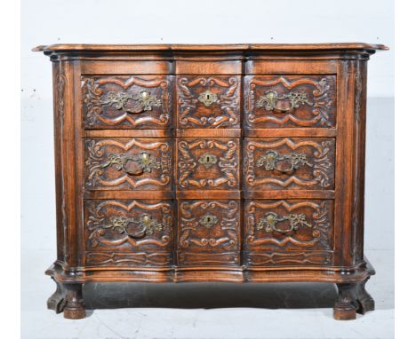 A carved oak commode, 18th century Dutch style, likely late 19th/early20th century, serpentine outline, three drawers, shaped