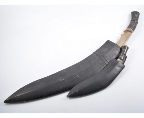 Two Eastern Kris knives, the largest fused in scabbard, shortest 36cm., (2)