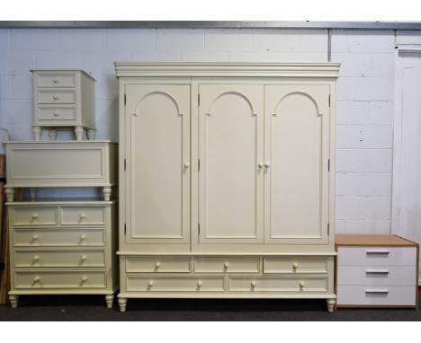 Contemporary cream painted bedroom suite, comprising triple wardrobe, chest of drawers, bedside table, dressing table mirror,