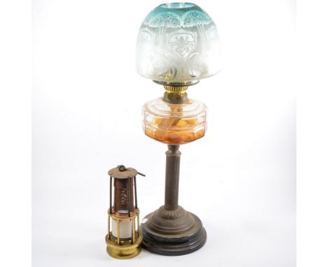 Brass oil lamp with decorative glass shade, pair of brass candle sticks and a miner's lamp, (4).