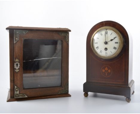 An oak smokers cabinet with plated mounts and wooden cigar holder, a mahogany cased mantel clock with domed top and tulip inl